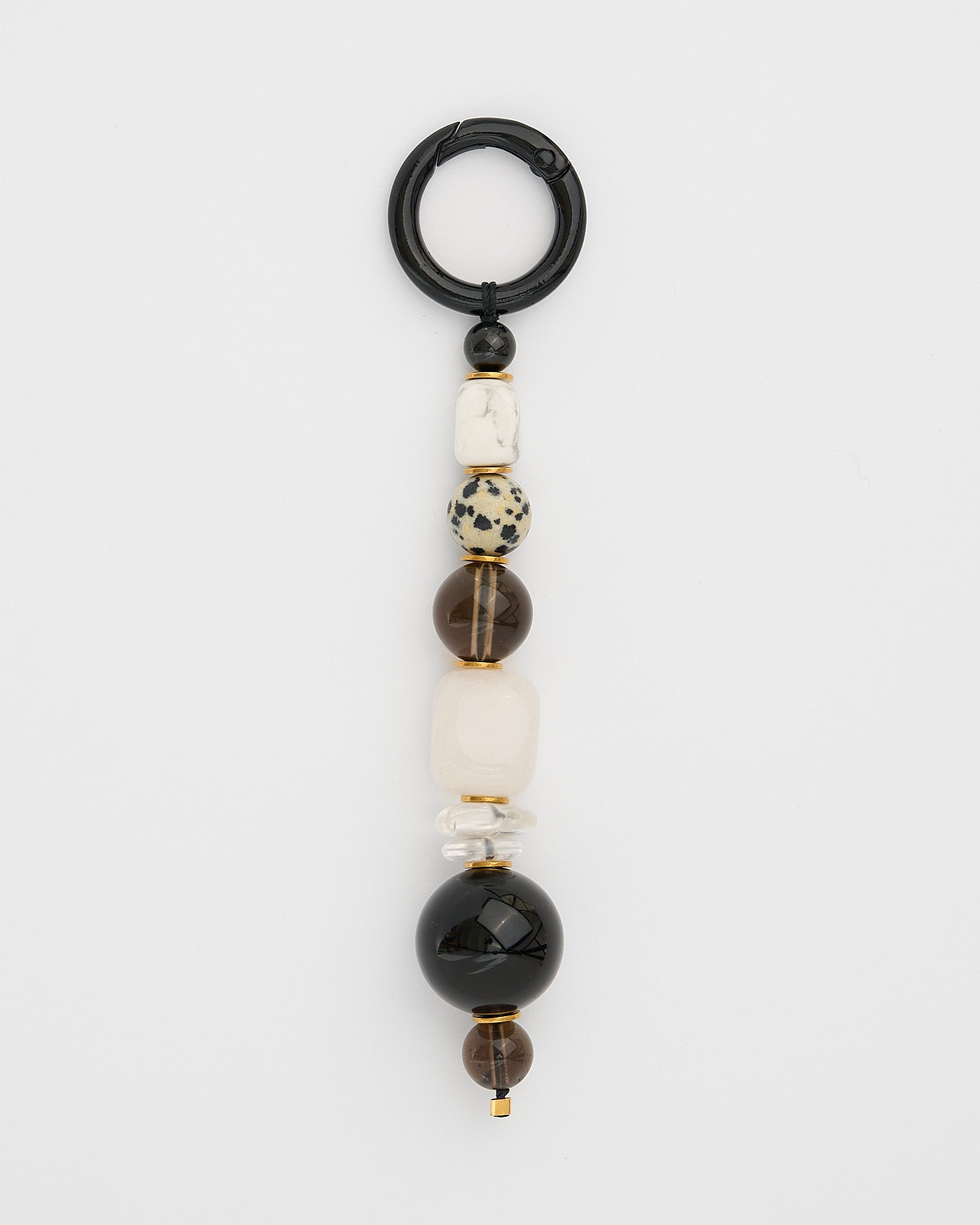 Beaded gemstone keychain with black, white, and brown beads on a white background